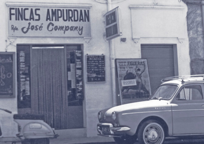 Fotografía antigua de un local comercial con el rótulo Fincas Ampurdan - Rpte. José Company